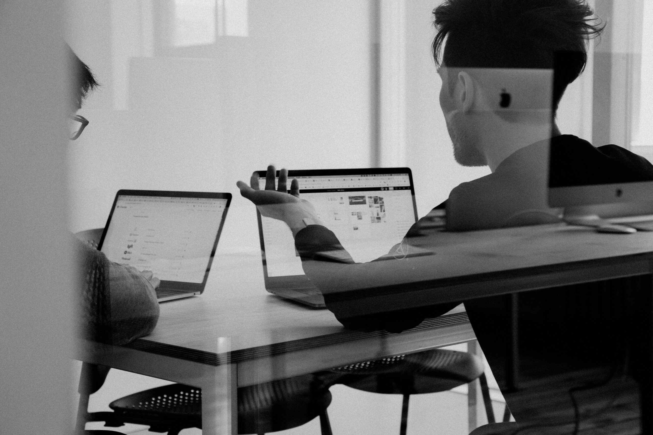 a man sitting at a table with a laptop