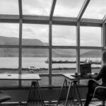 a woman sitting at a table with a laptop